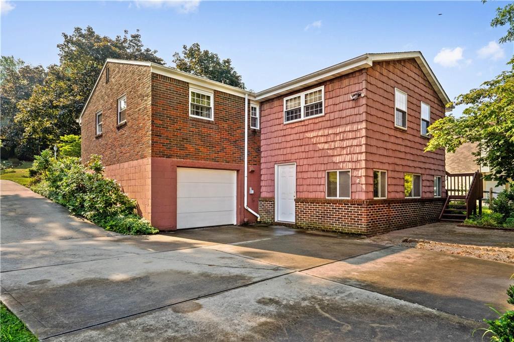 106 Fenway Road Pittsburgh, PA 15209 - Photo 2 of 25 a front view of a house with a yard and garage