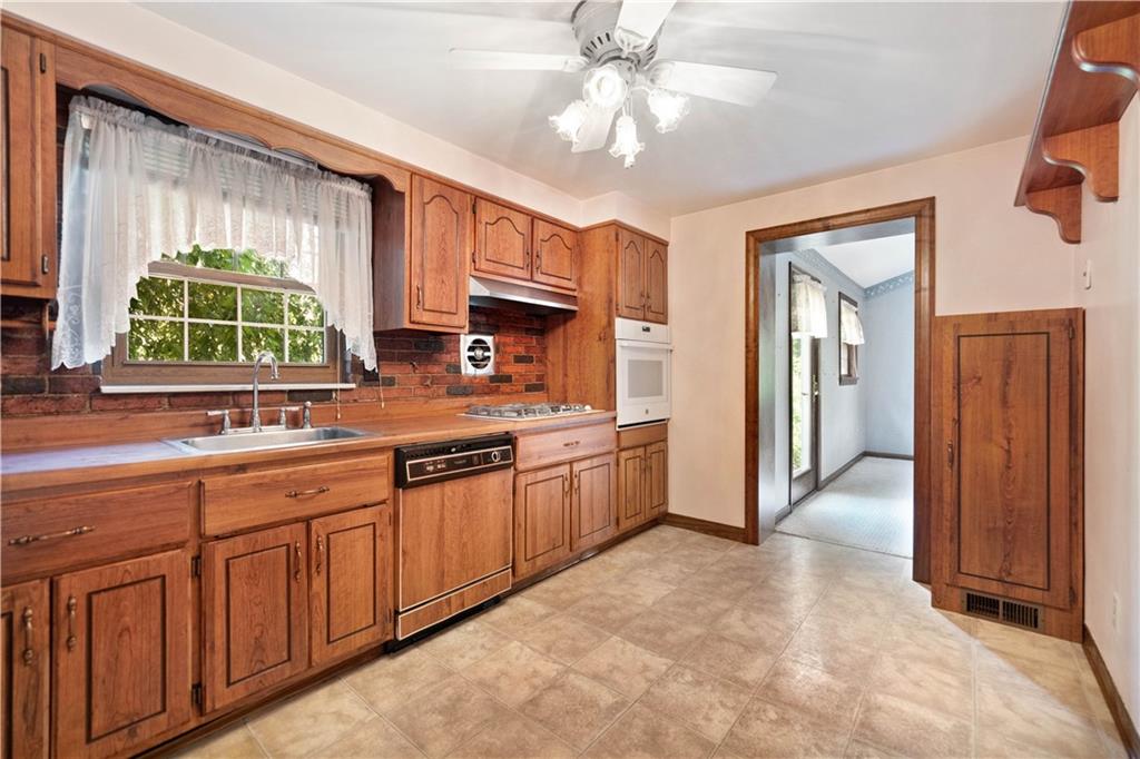 106 Fenway Road Pittsburgh, PA 15209 - Photo 12 of 25 a large kitchen with cabinets and wooden floor