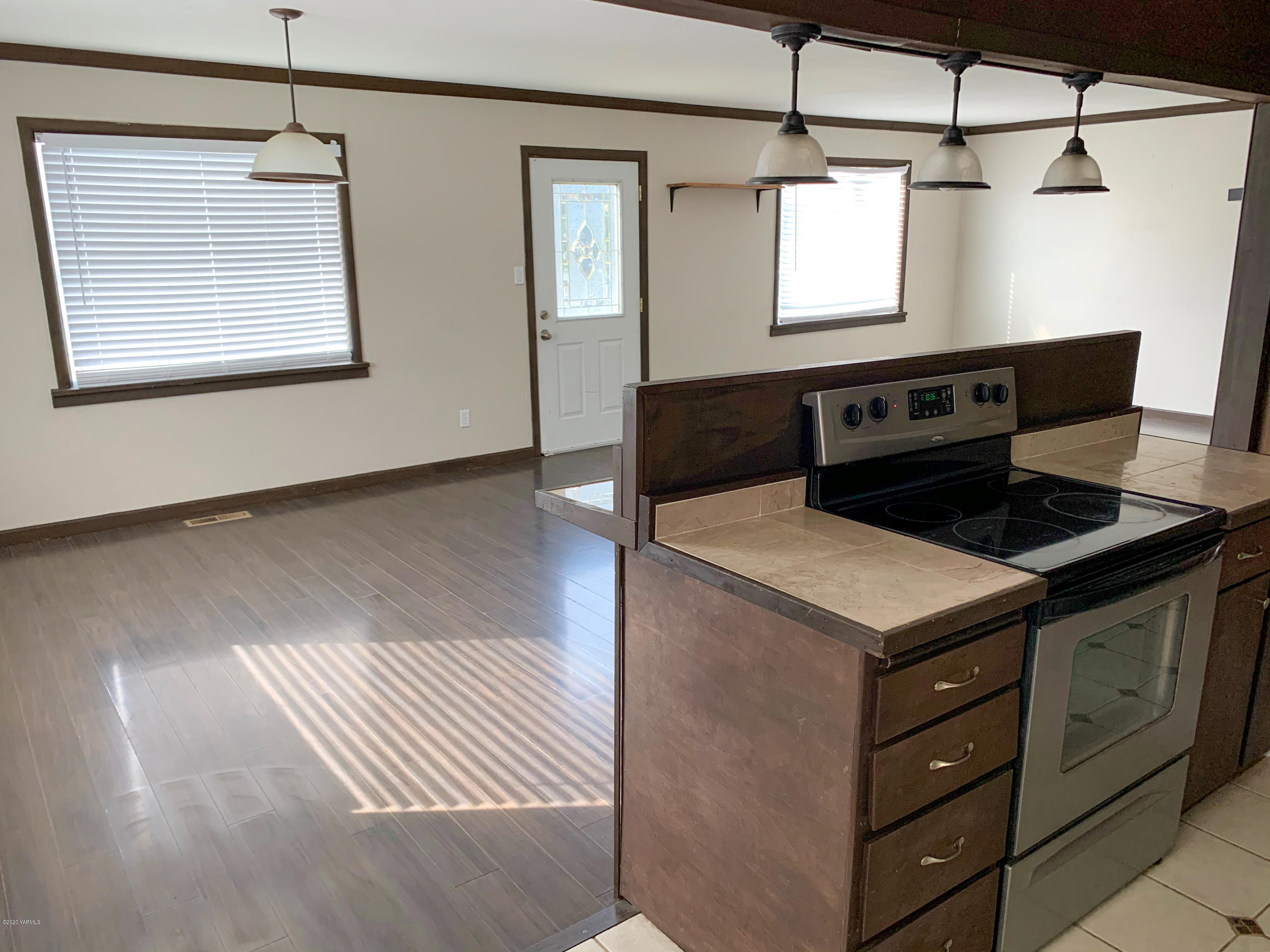 803 Speyers Road Selah, WA 98942 - Photo 14 of 38 a kitchen with a stove and a wooden floor