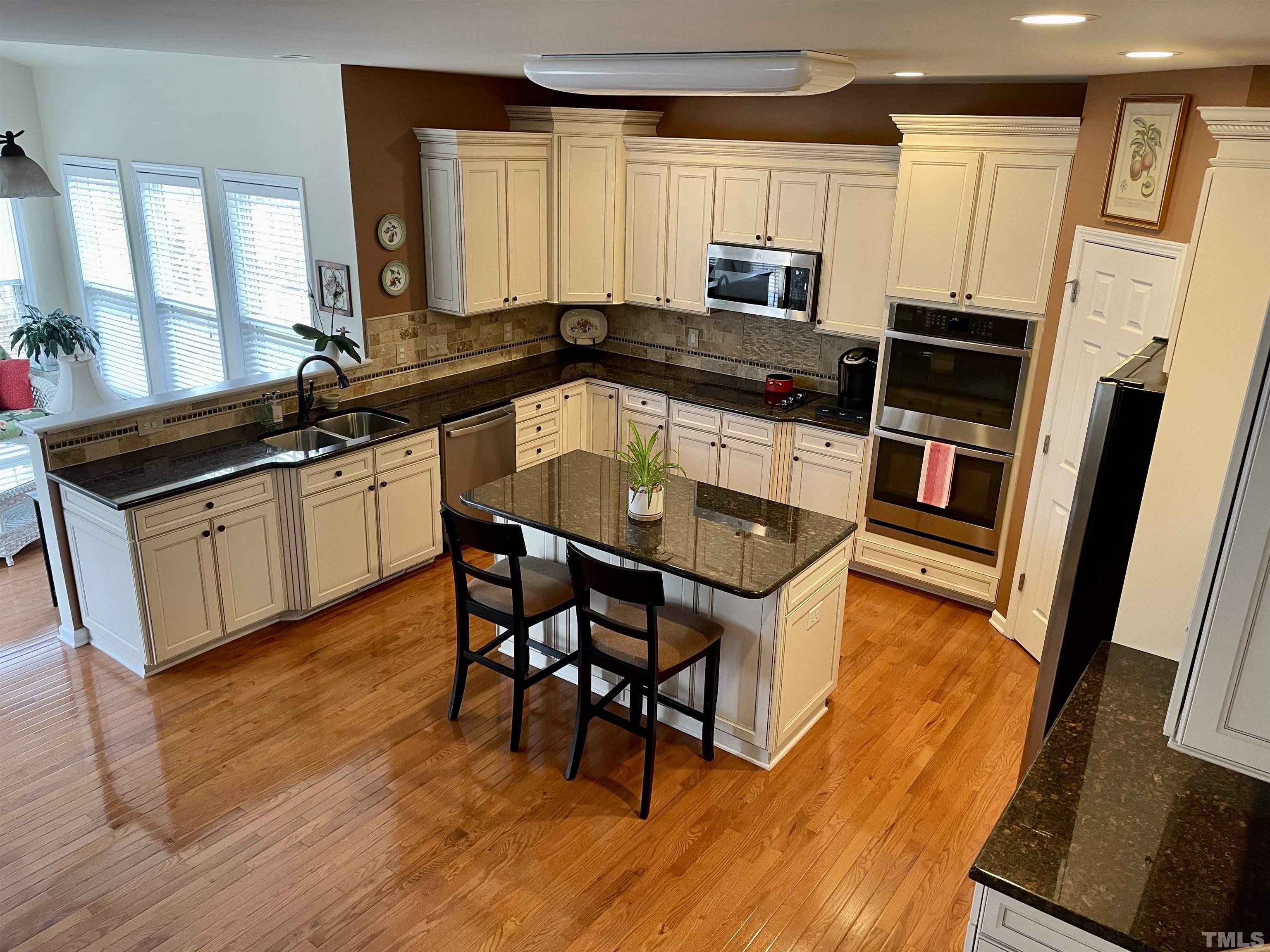 891 Seastone Street Raleigh, NC 27603 - Photo 1 of 51 a kitchen with stainless steel appliances granite countertop a stove a sink and a refrigerator