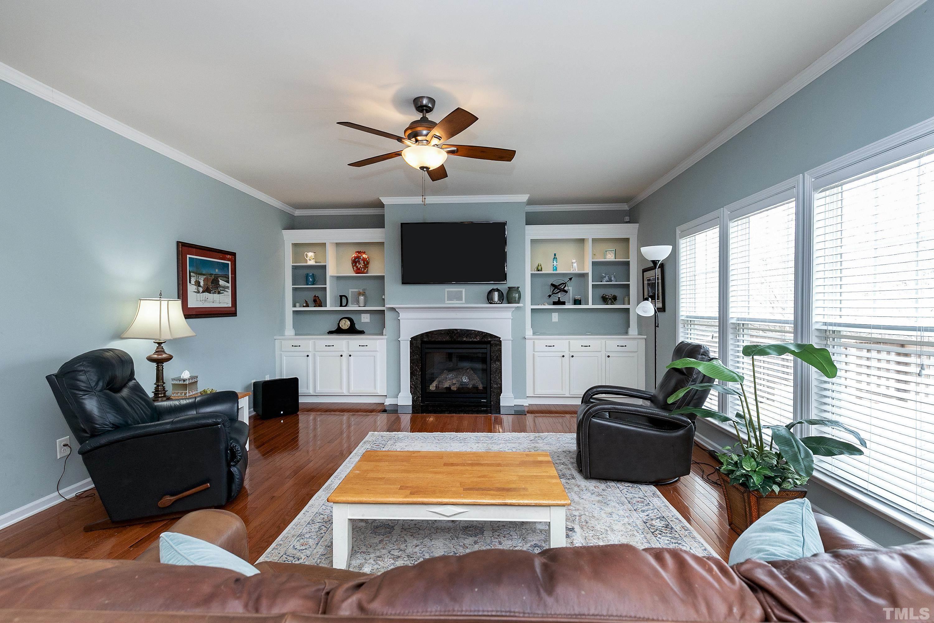 891 Seastone Street Raleigh, NC 27603 - Photo 12 of 51 a living room with furniture a flat screen tv and a fireplace