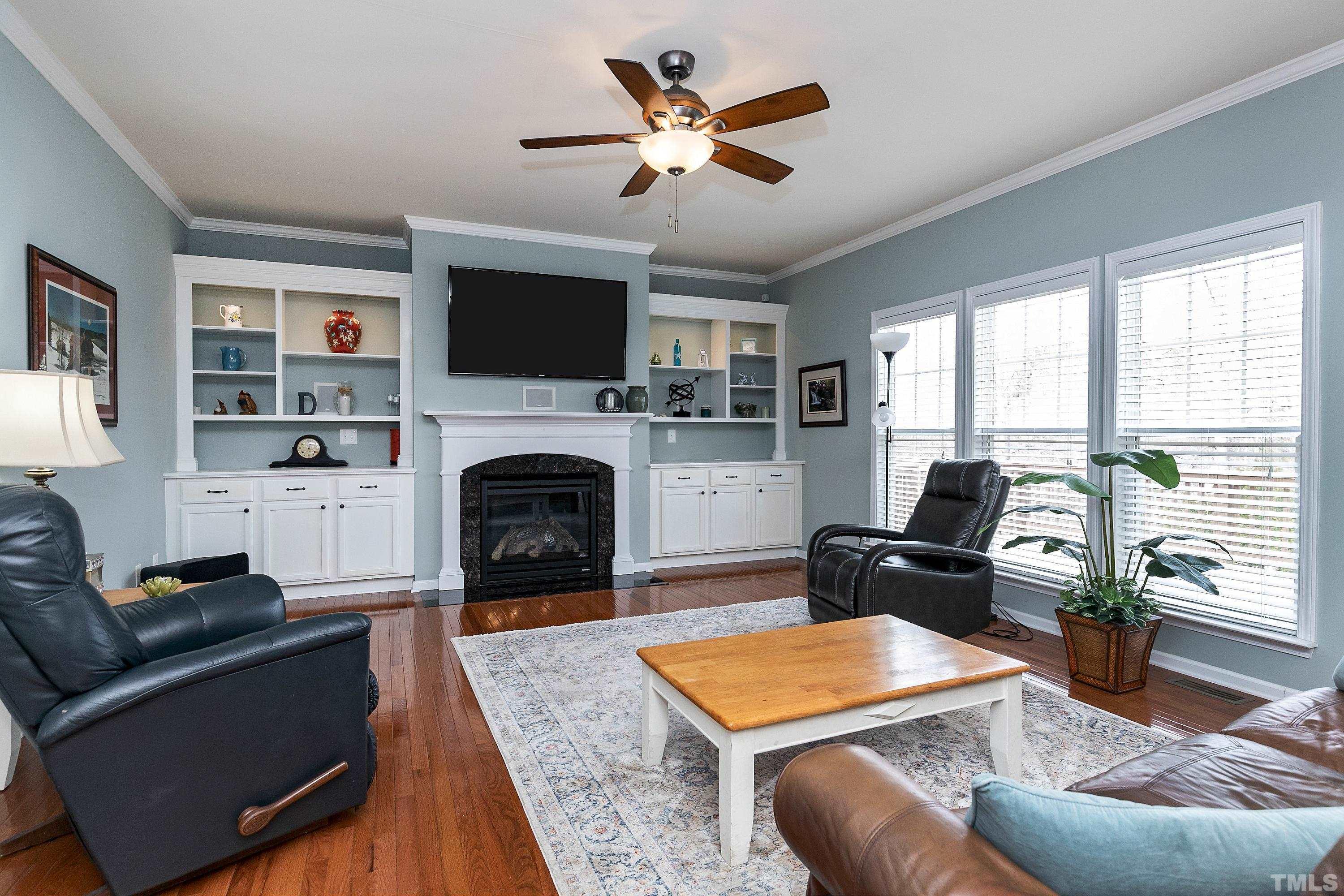 891 Seastone Street Raleigh, NC 27603 - Photo 13 of 51 a living room with furniture a flat screen tv and a fireplace