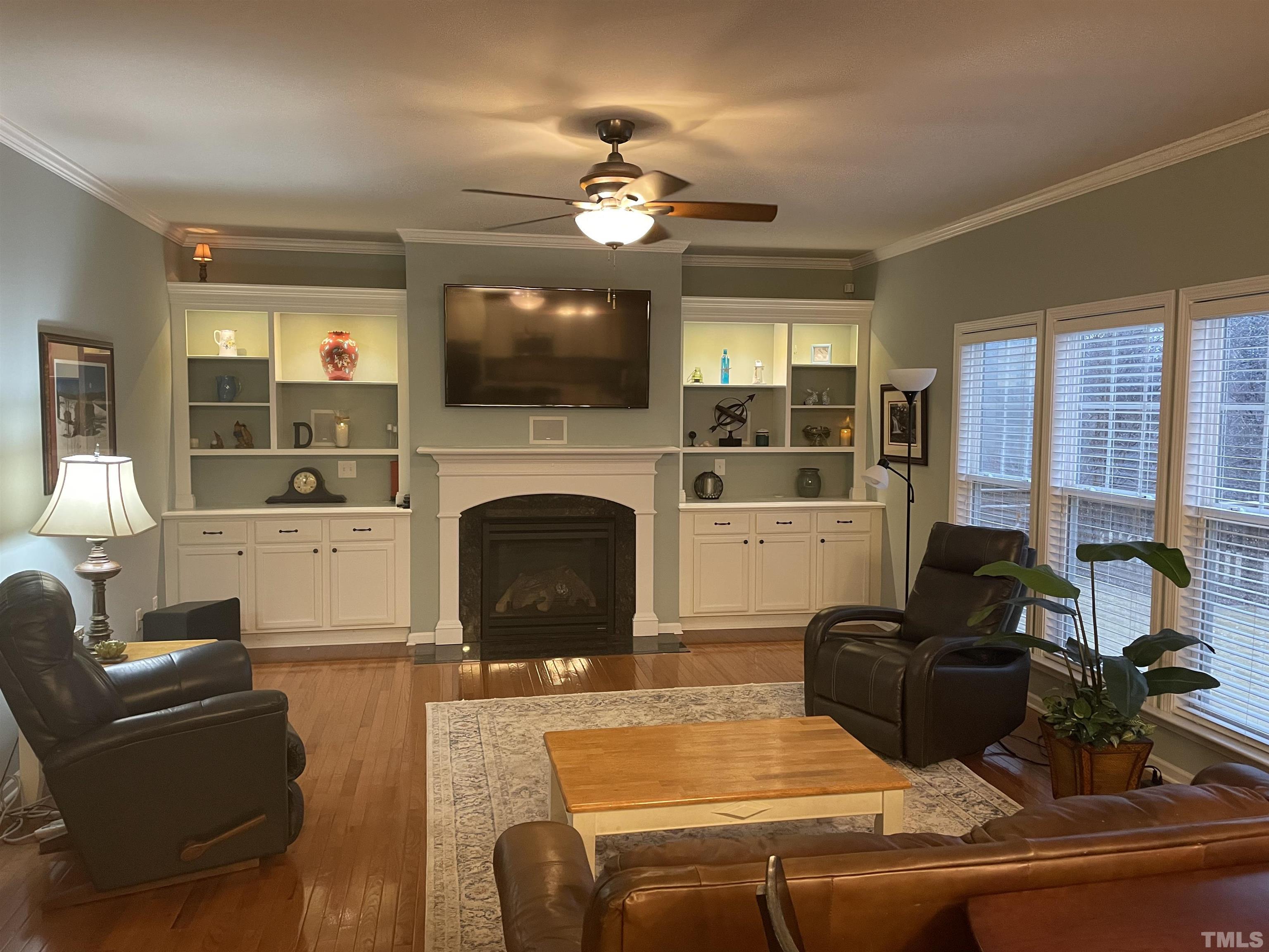 891 Seastone Street Raleigh, NC 27603 - Photo 2 of 51 a living room with furniture a flat screen tv and a fireplace
