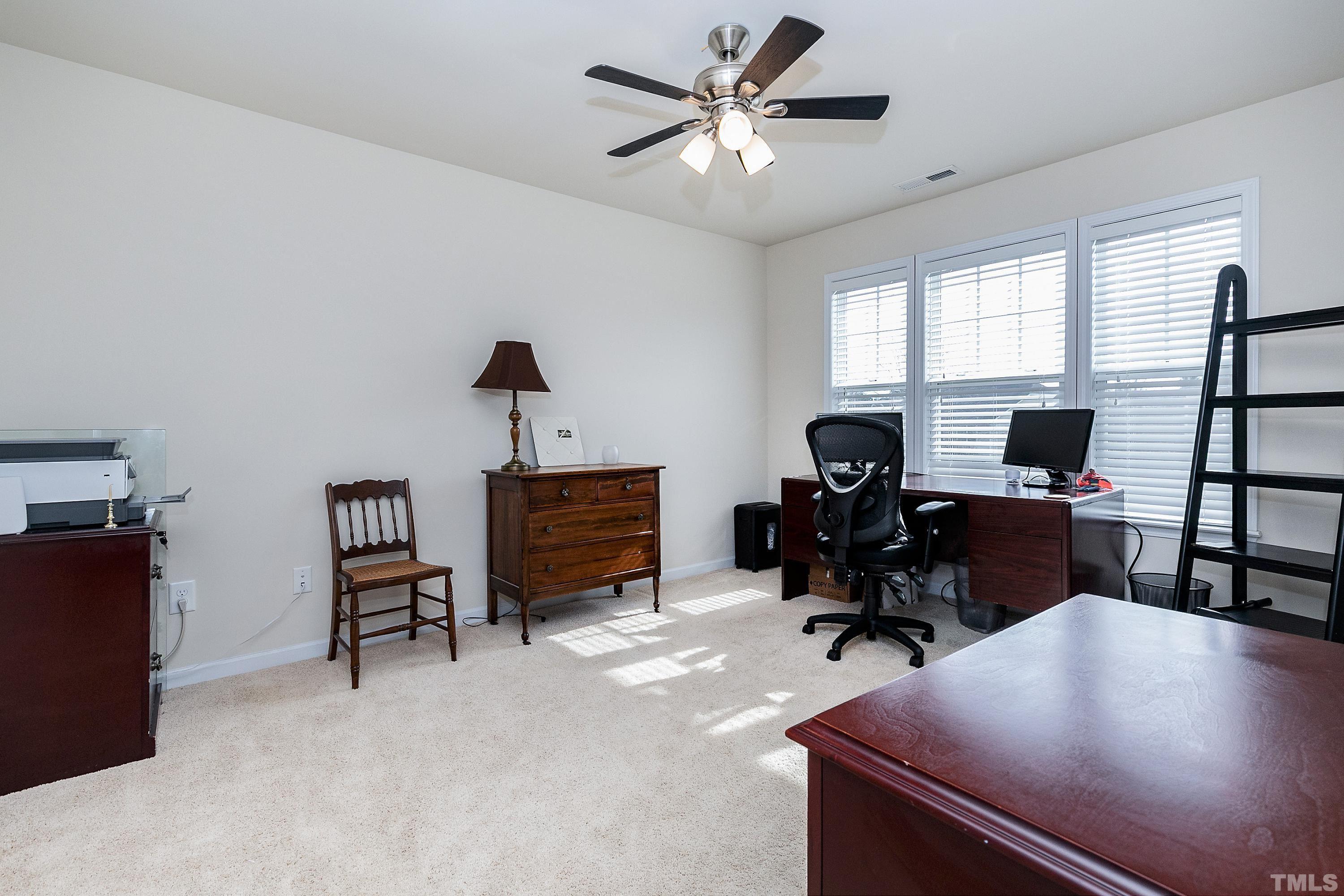 891 Seastone Street Raleigh, NC 27603 - Photo 24 of 51 a view of a workspace with furniture and a window