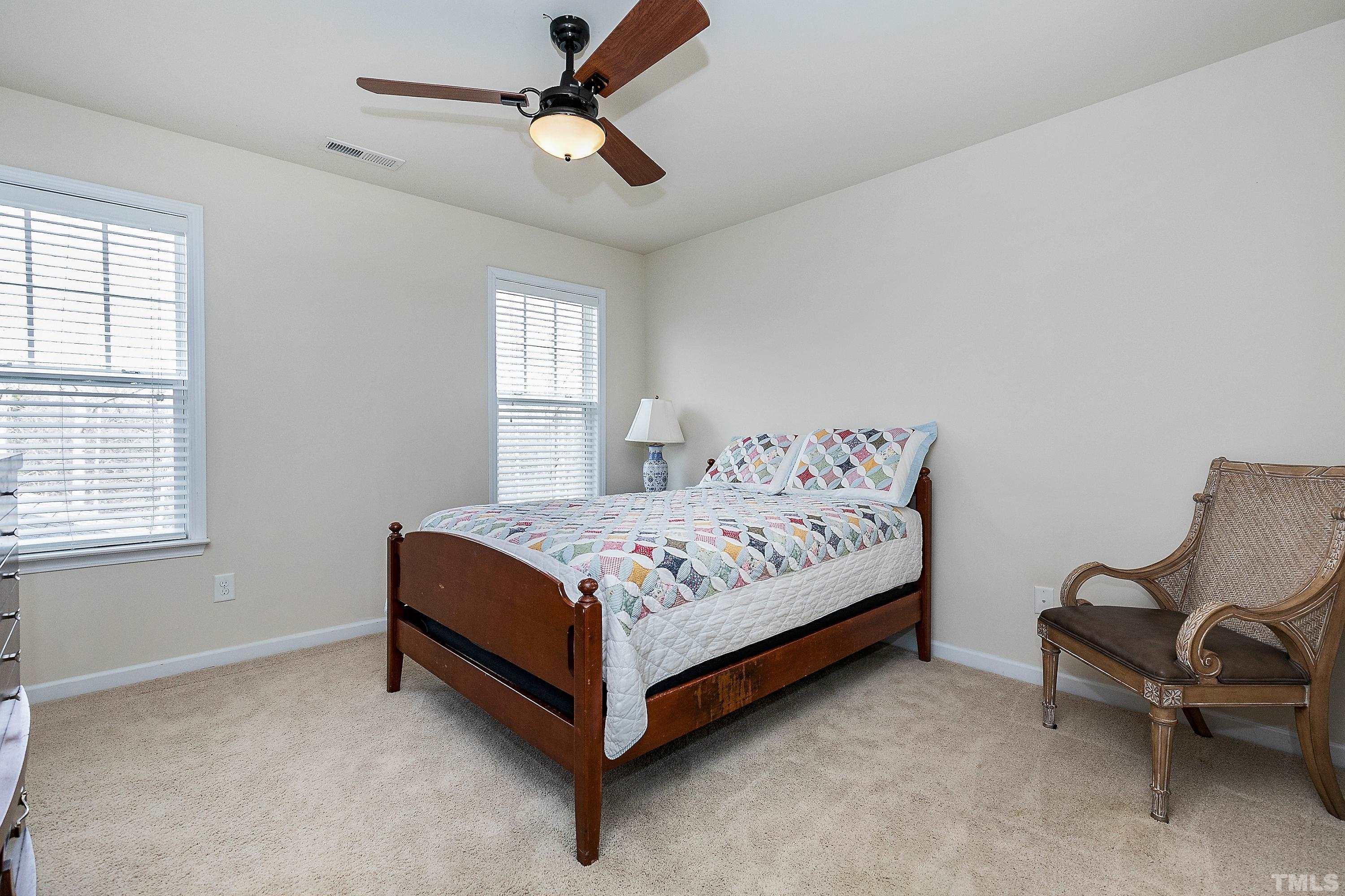 891 Seastone Street Raleigh, NC 27603 - Photo 25 of 51 a bed sitting in a bedroom next to a window