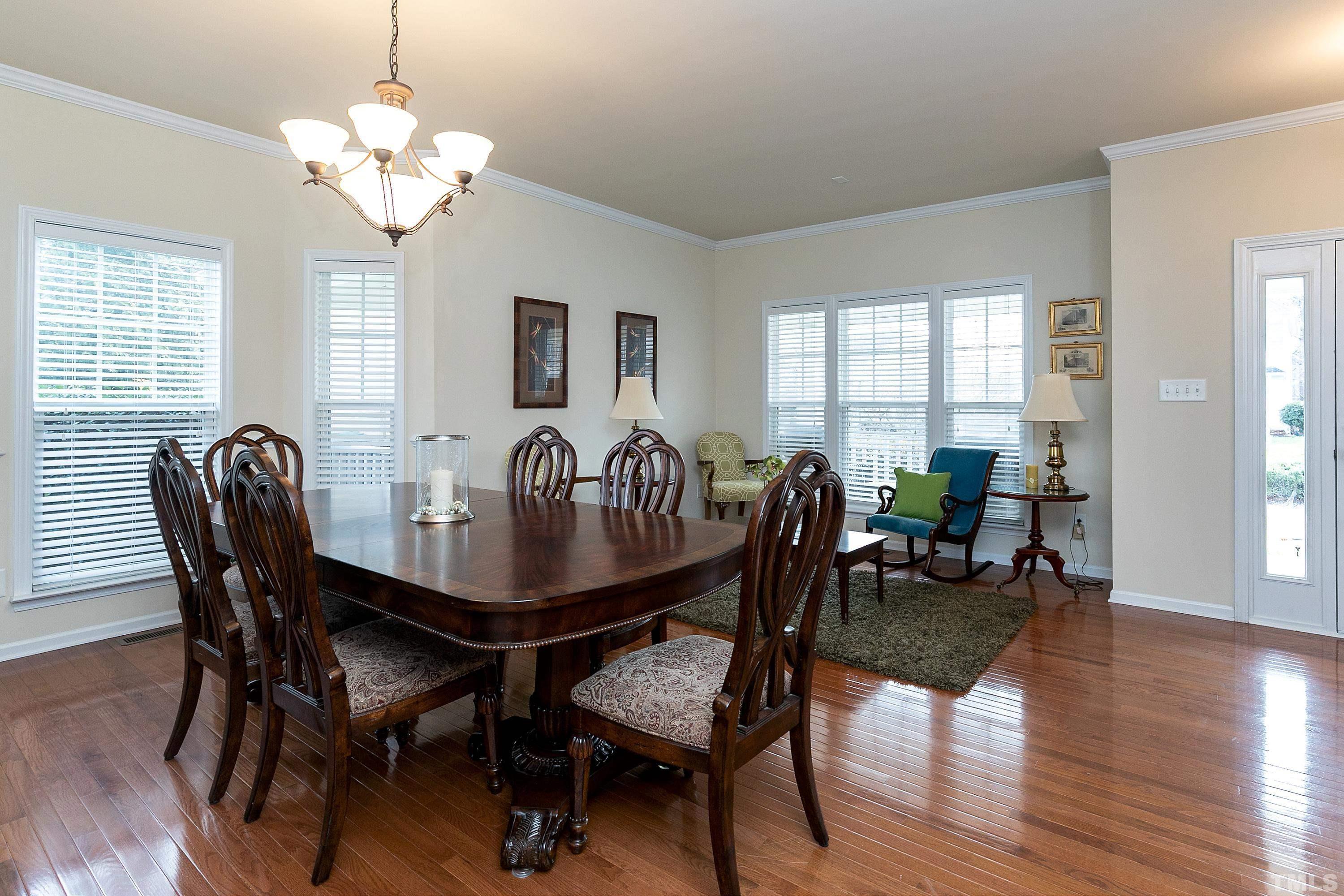 891 Seastone Street Raleigh, NC 27603 - Photo 5 of 51 a view of a dining room with furniture and wooden floor