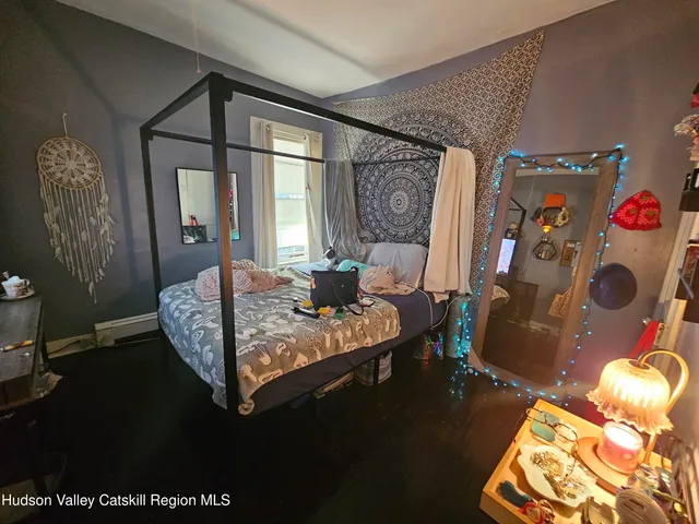 a bedroom with furniture and a flat screen tv