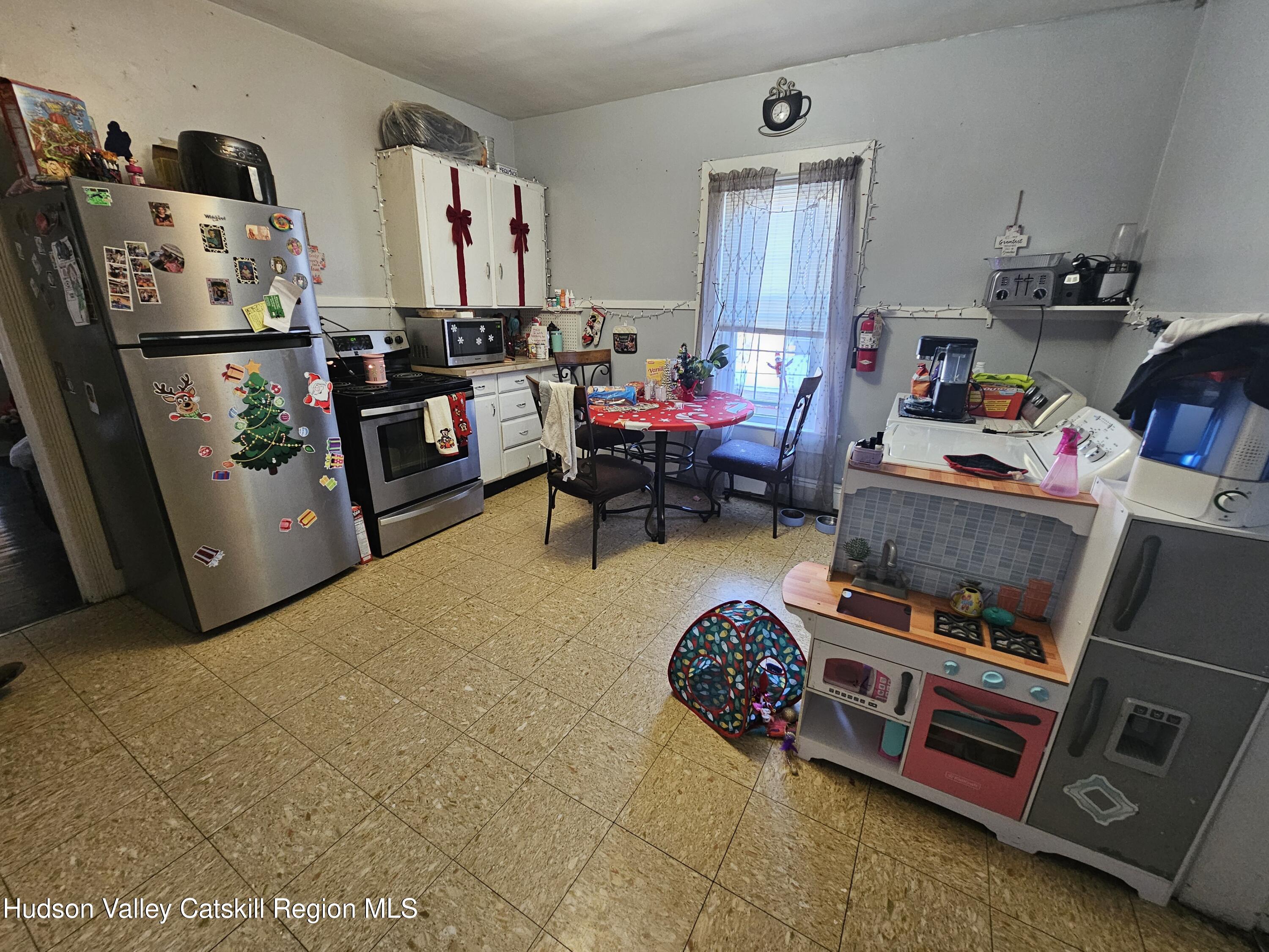94 Main Street Philmont, NY 12534 - Photo 19 of 31 a bed room with a bed furniture and a tv