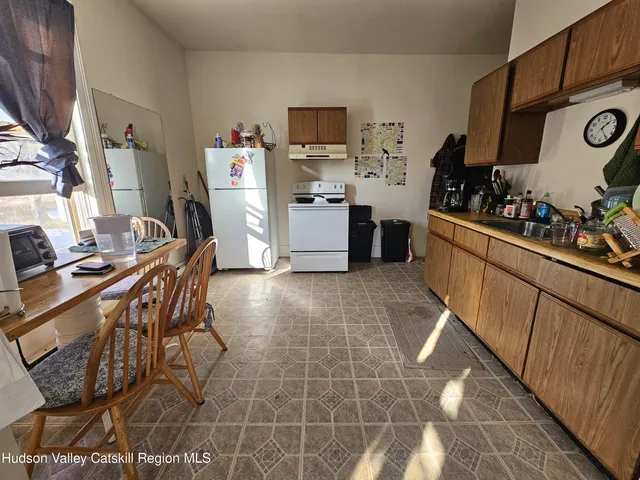 a bedroom with furniture and a flat screen tv