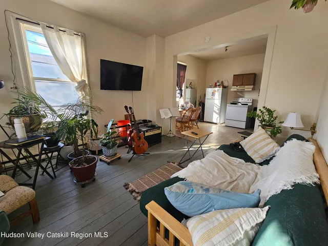 a kitchen with a refrigerator and a stove top oven