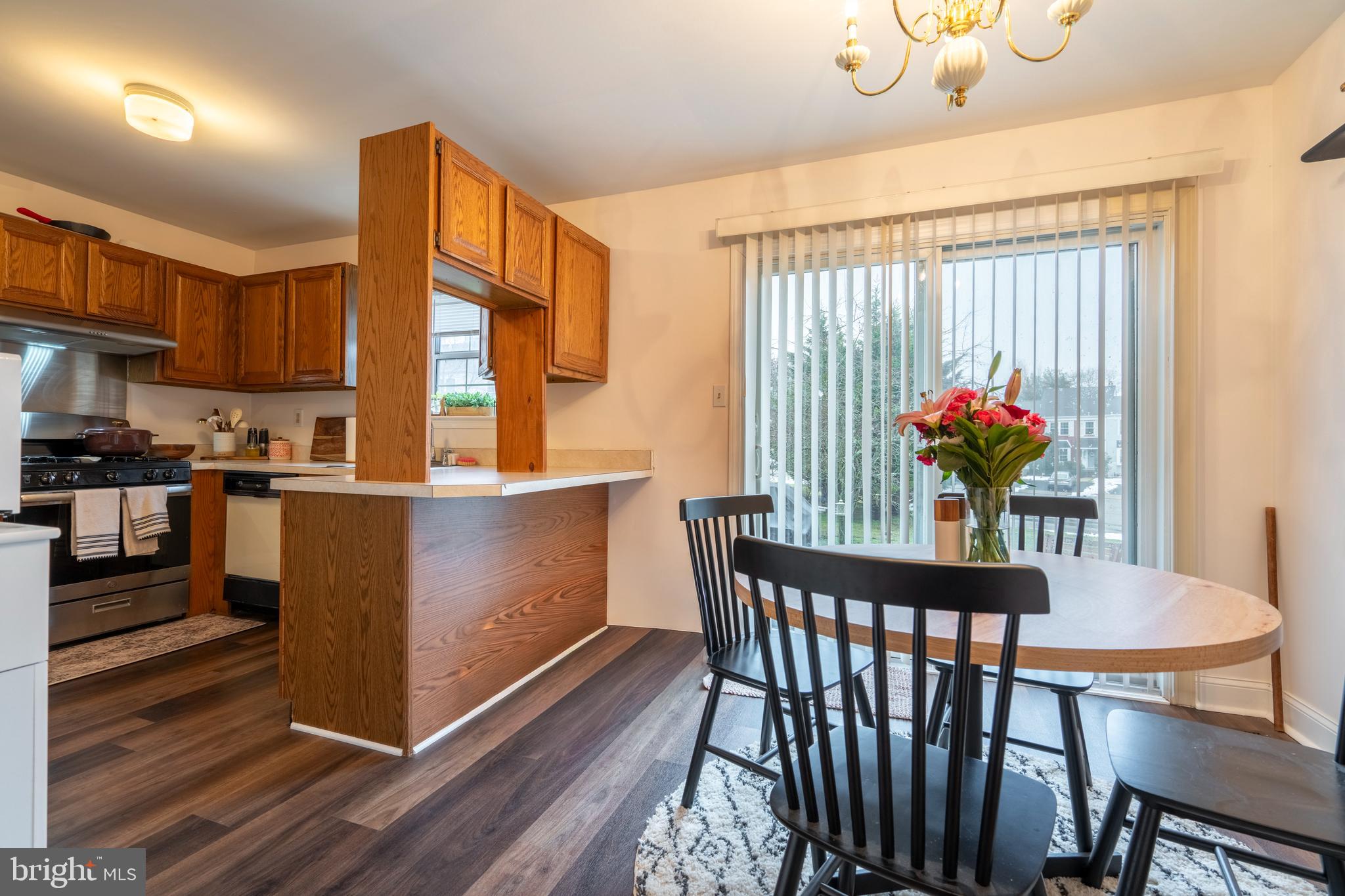 1410 Sentry Lane Eagleville, PA 19403 - Photo 14 of 32 a dining room with furniture potted plants and wooden floor