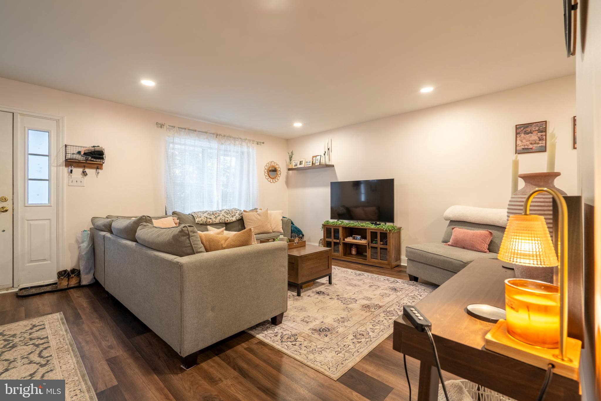 1410 Sentry Lane Eagleville, PA 19403 - Photo 6 of 32 a living room with furniture and a flat screen tv
