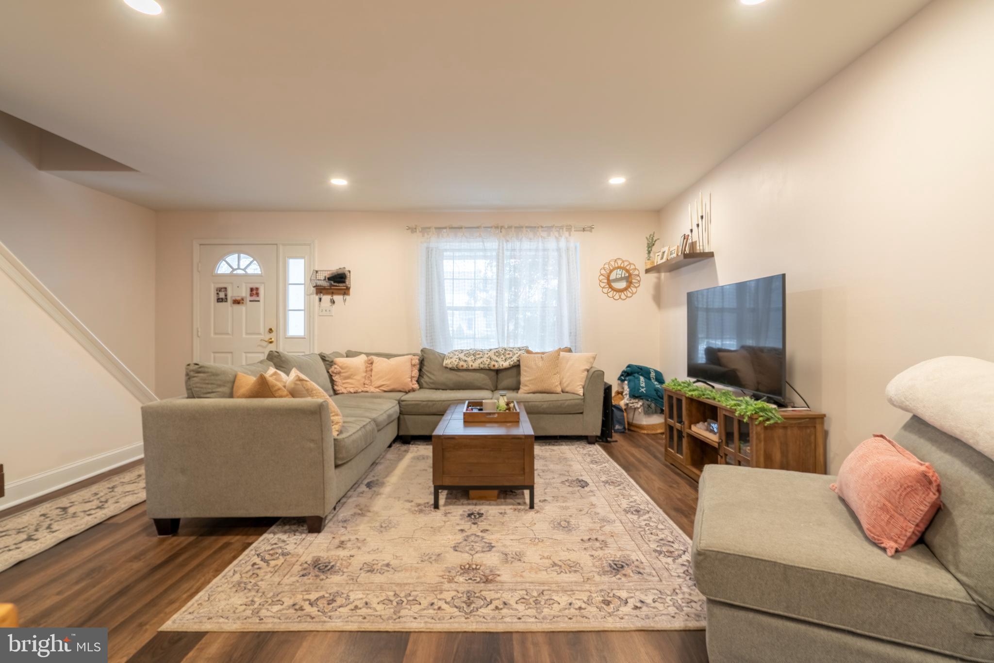1410 Sentry Lane Eagleville, PA 19403 - Photo 8 of 32 a living room with couches and a flat screen tv