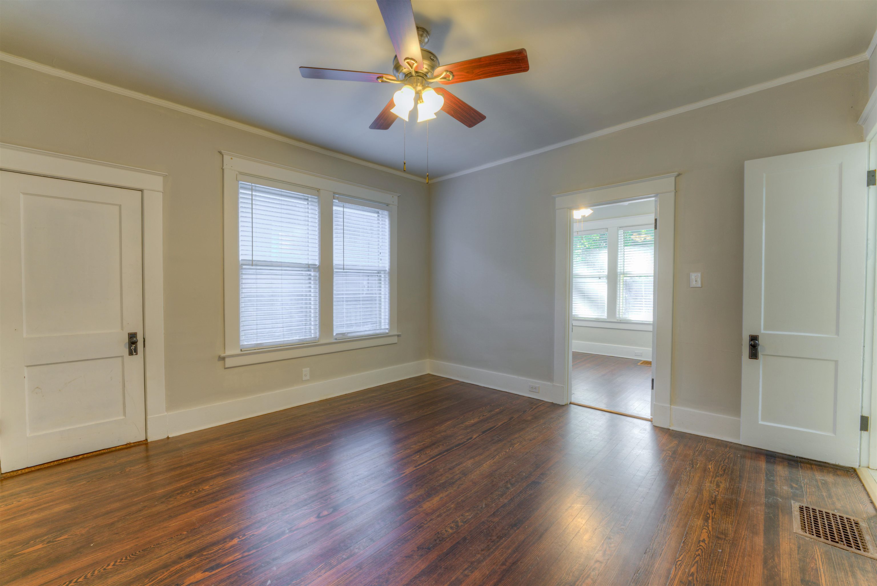 191 Lemaster Street Memphis, TN 38104 - Photo 15 of 27 Empty room with dark wood-type flooring, crown molding, and a ceiling fan