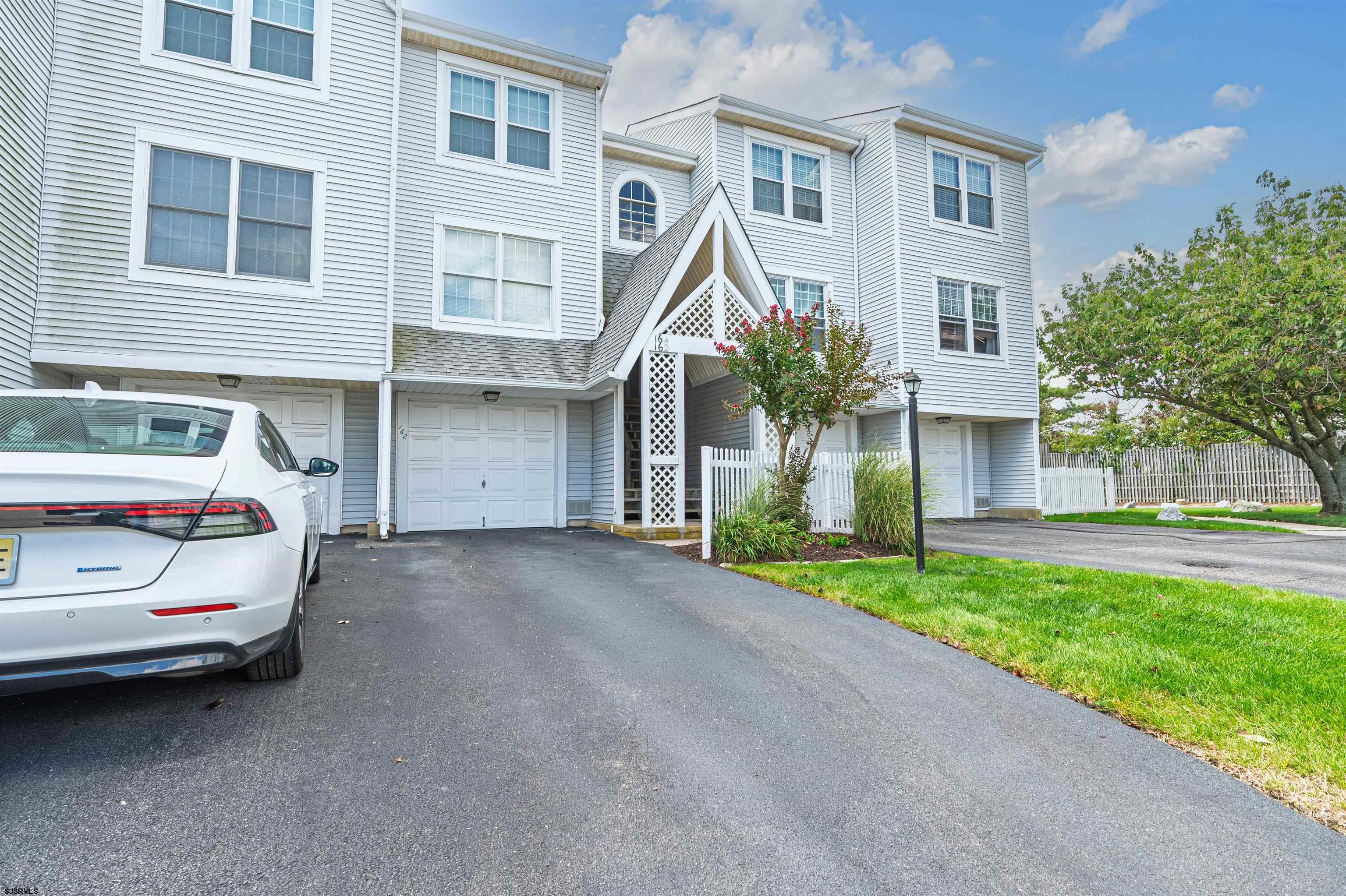 162 39th Street South, Unit 162 Brigantine, NJ 08203 - Photo 1 of 16 a front view of a house with a yard and garage