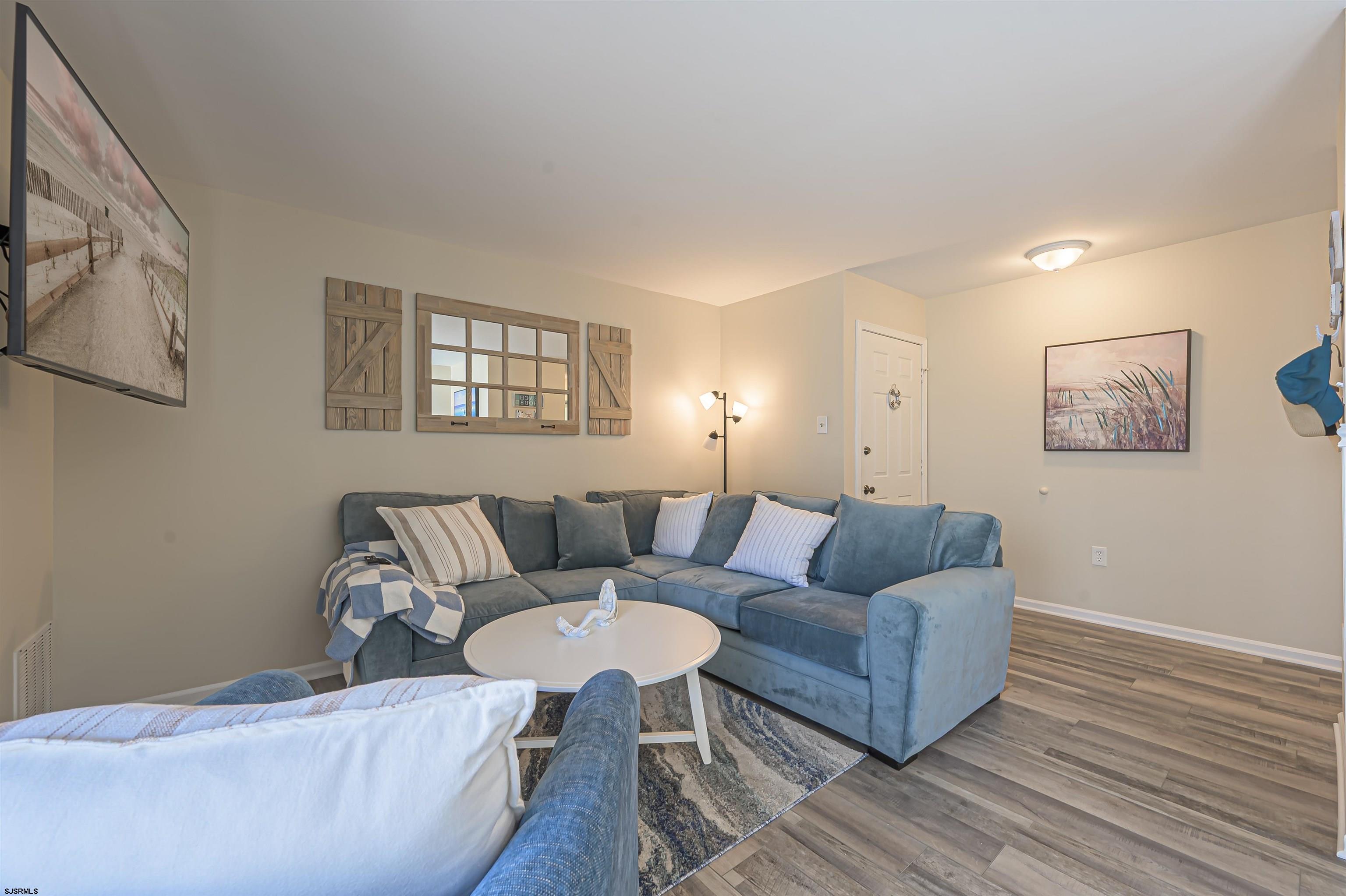 162 39th Street South, Unit 162 Brigantine, NJ 08203 - Photo 3 of 16 a living room with furniture and a wooden floor