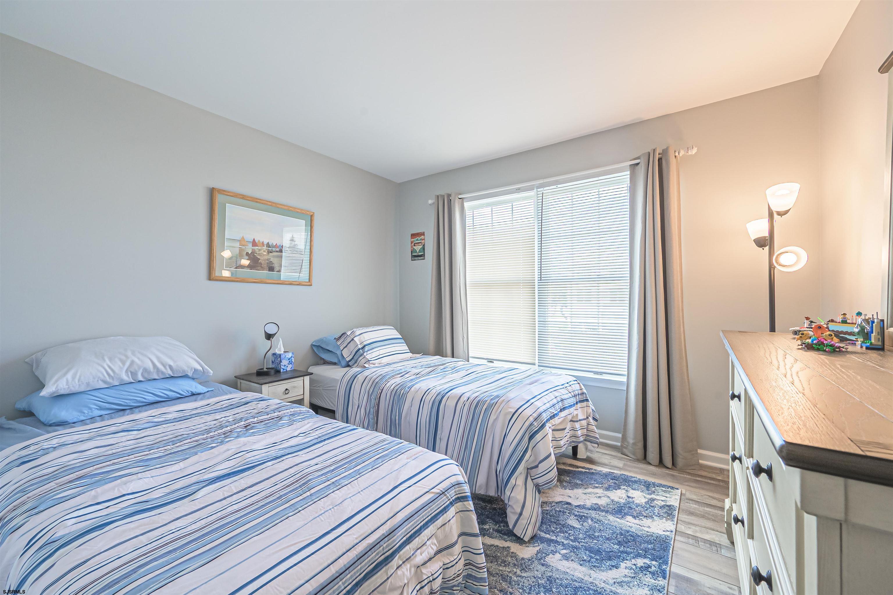162 39th Street South, Unit 162 Brigantine, NJ 08203 - Photo 9 of 16 a bedroom with two beds and a dresser