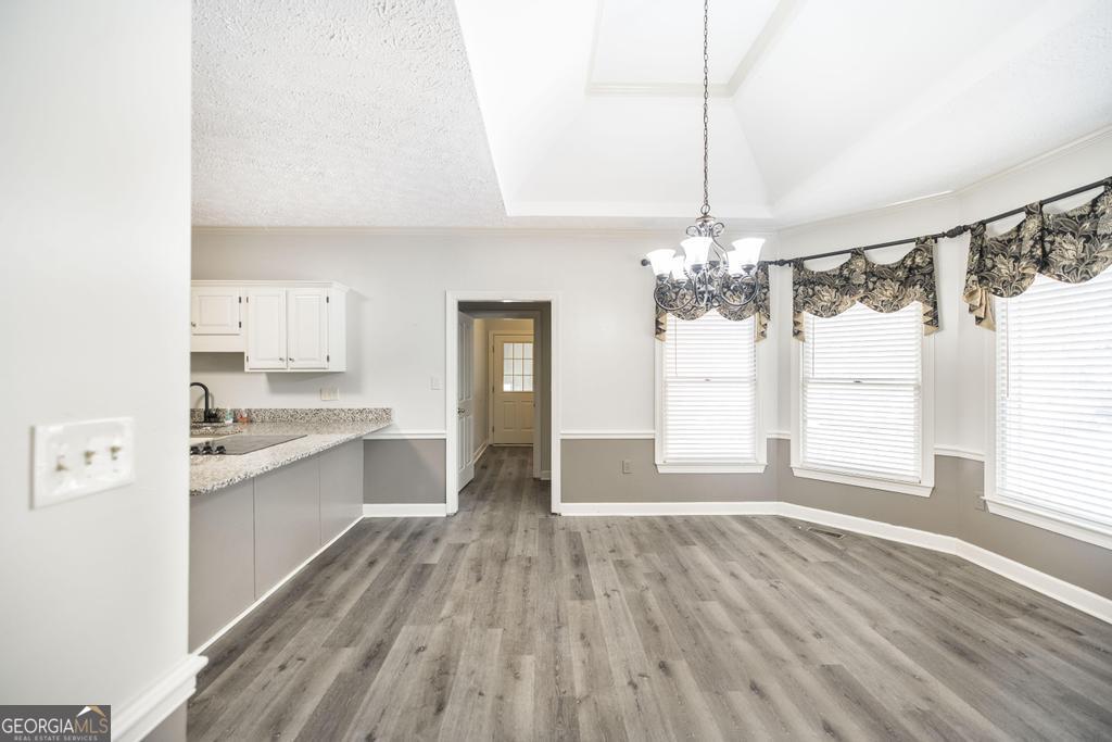 3077 River Ridge Drive Macon, GA 31204 - Photo 12 of 35 a open kitchen with kitchen island white cabinets and stainless steel appliances
