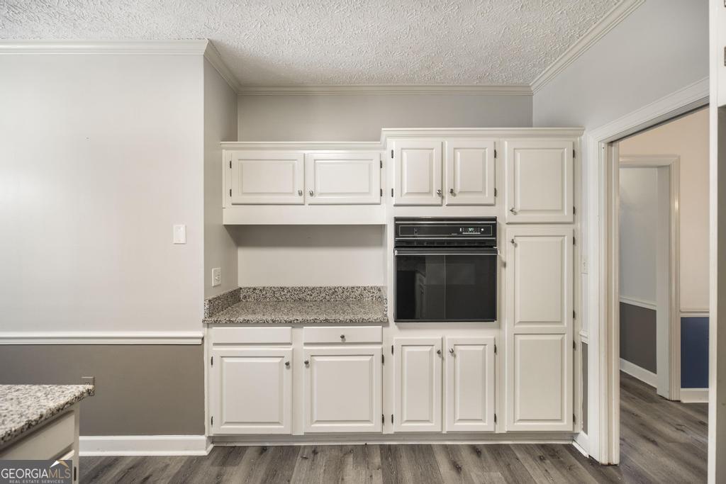 3077 River Ridge Drive Macon, GA 31204 - Photo 16 of 35 a kitchen with granite countertop white cabinets and stainless steel appliances