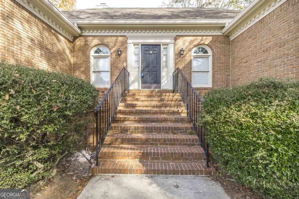 3077 River Ridge Drive Macon, GA 31204 - Photo 2 of 35 a front view of a house with a yard