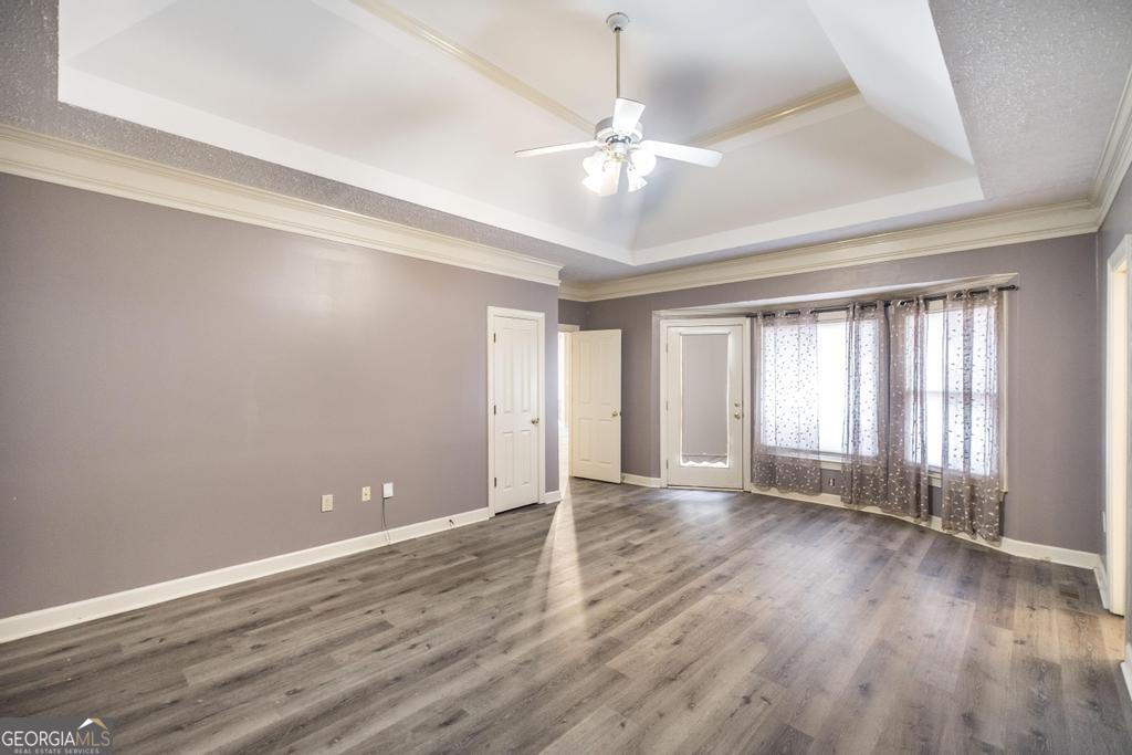 3077 River Ridge Drive Macon, GA 31204 - Photo 21 of 35 an empty room with wooden floor and windows