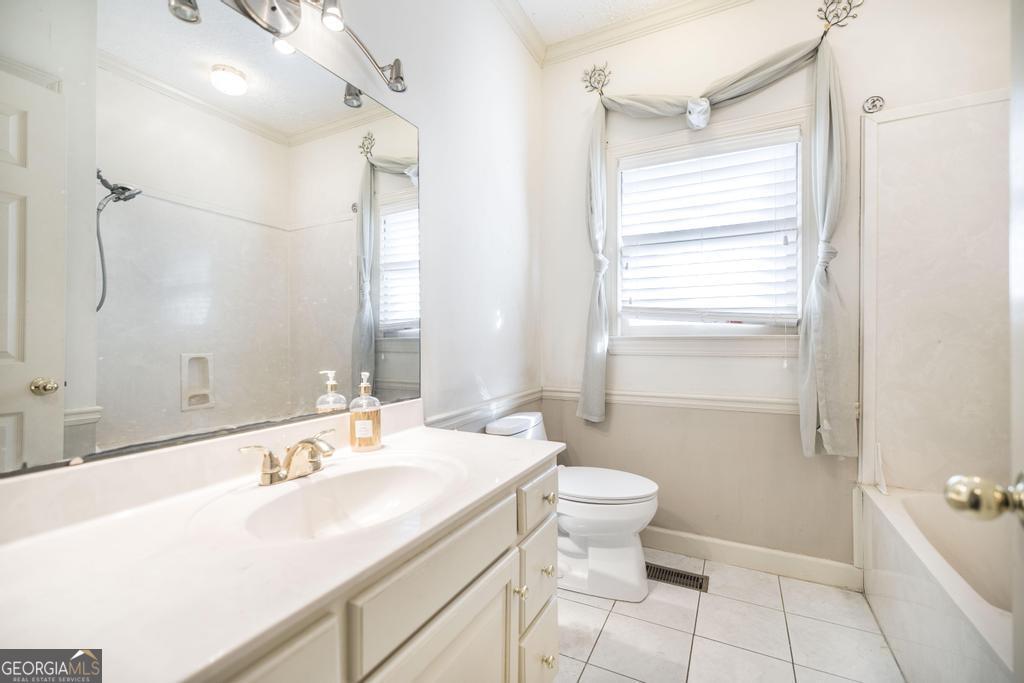 3077 River Ridge Drive Macon, GA 31204 - Photo 28 of 35 a bathroom with a sink toilet double vanity and shower