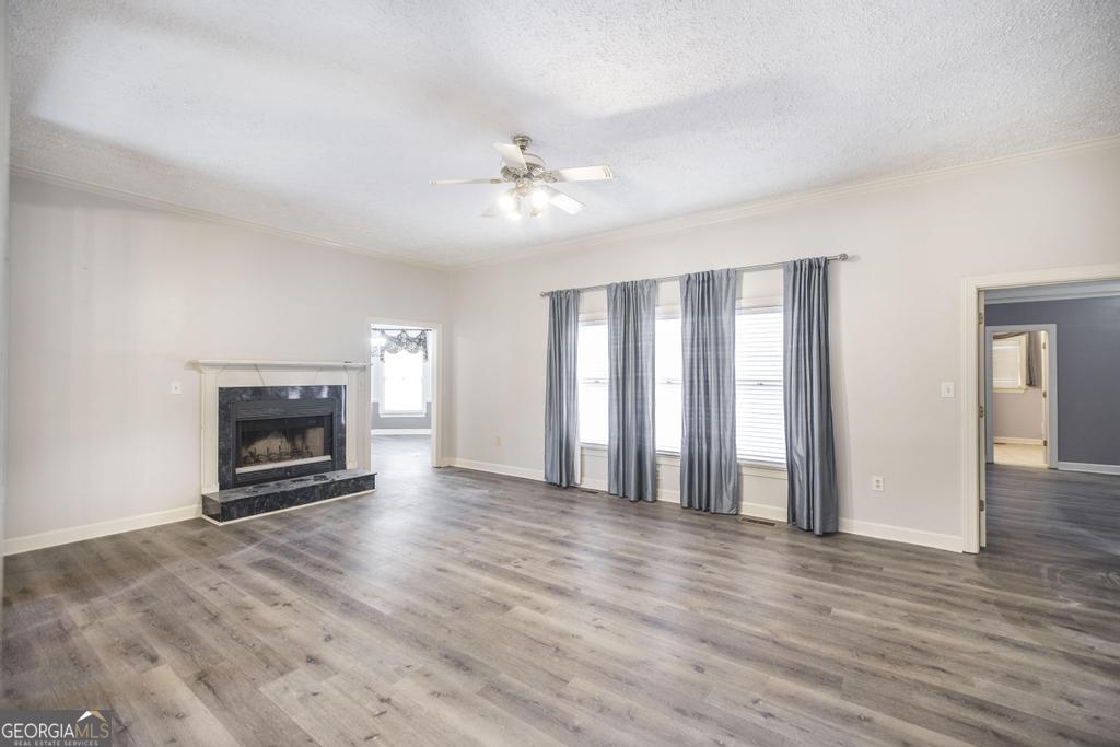 3077 River Ridge Drive Macon, GA 31204 - Photo 9 of 35 wooden floor fireplace and windows in an empty room