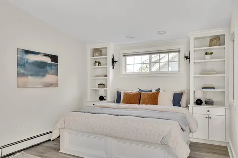 a bedroom with a large bed and a window