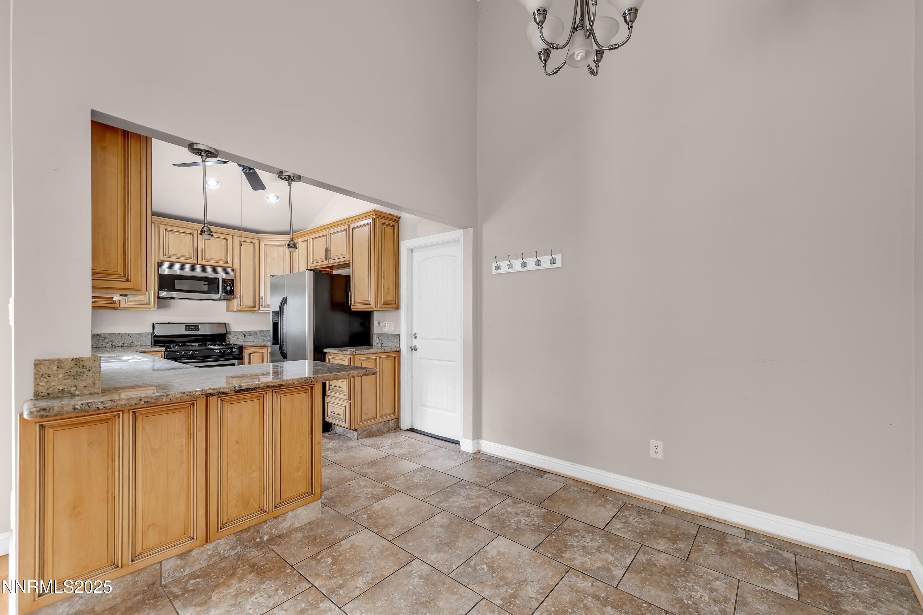 1220 Conway Lane Reno, NV 89503 - Photo 11 of 30 a kitchen with stainless steel appliances granite countertop a refrigerator a stove top oven a sink and dishwasher
