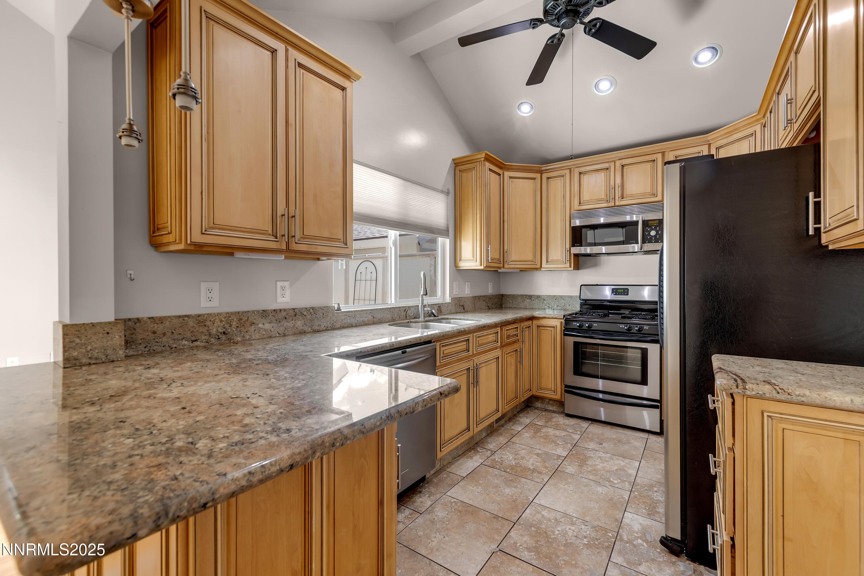 1220 Conway Lane Reno, NV 89503 - Photo 3 of 30 a kitchen with stainless steel appliances granite countertop a stove a sink and a refrigerator