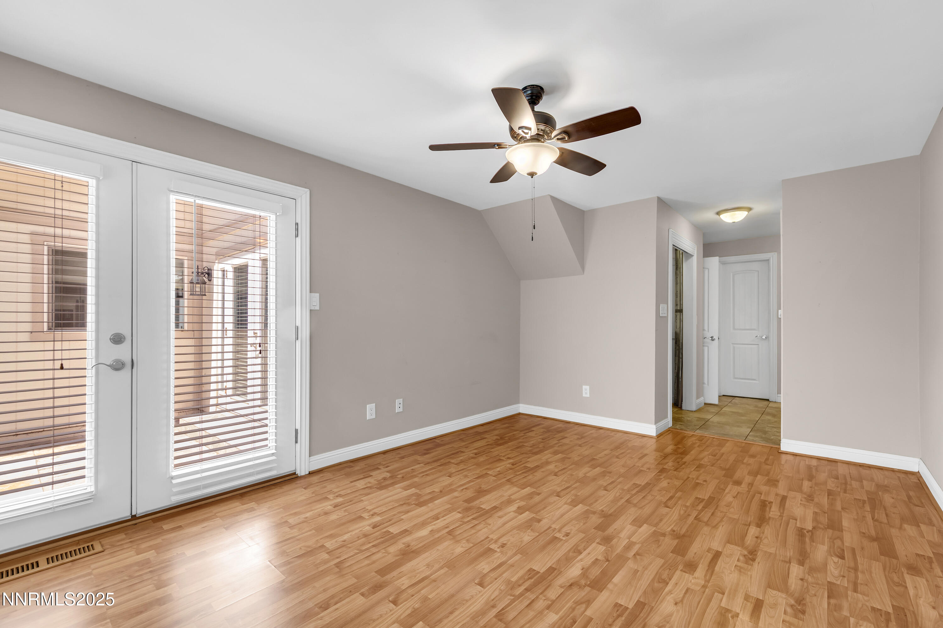 1220 Conway Lane Reno, NV 89503 - Photo 8 of 30 a view of an empty room with wooden floor and a window