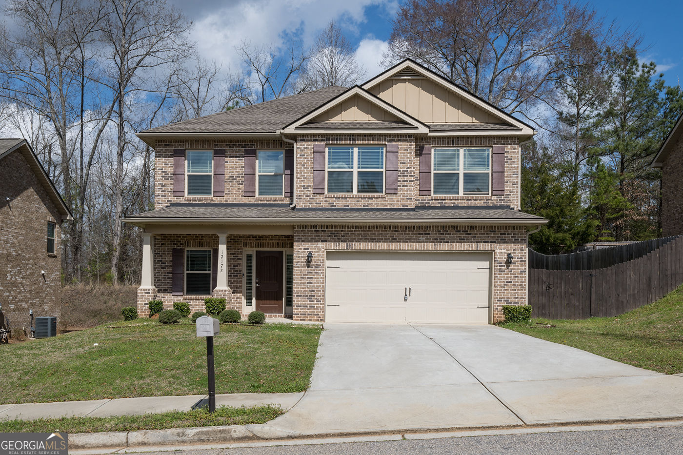 a front view of a house with a garden