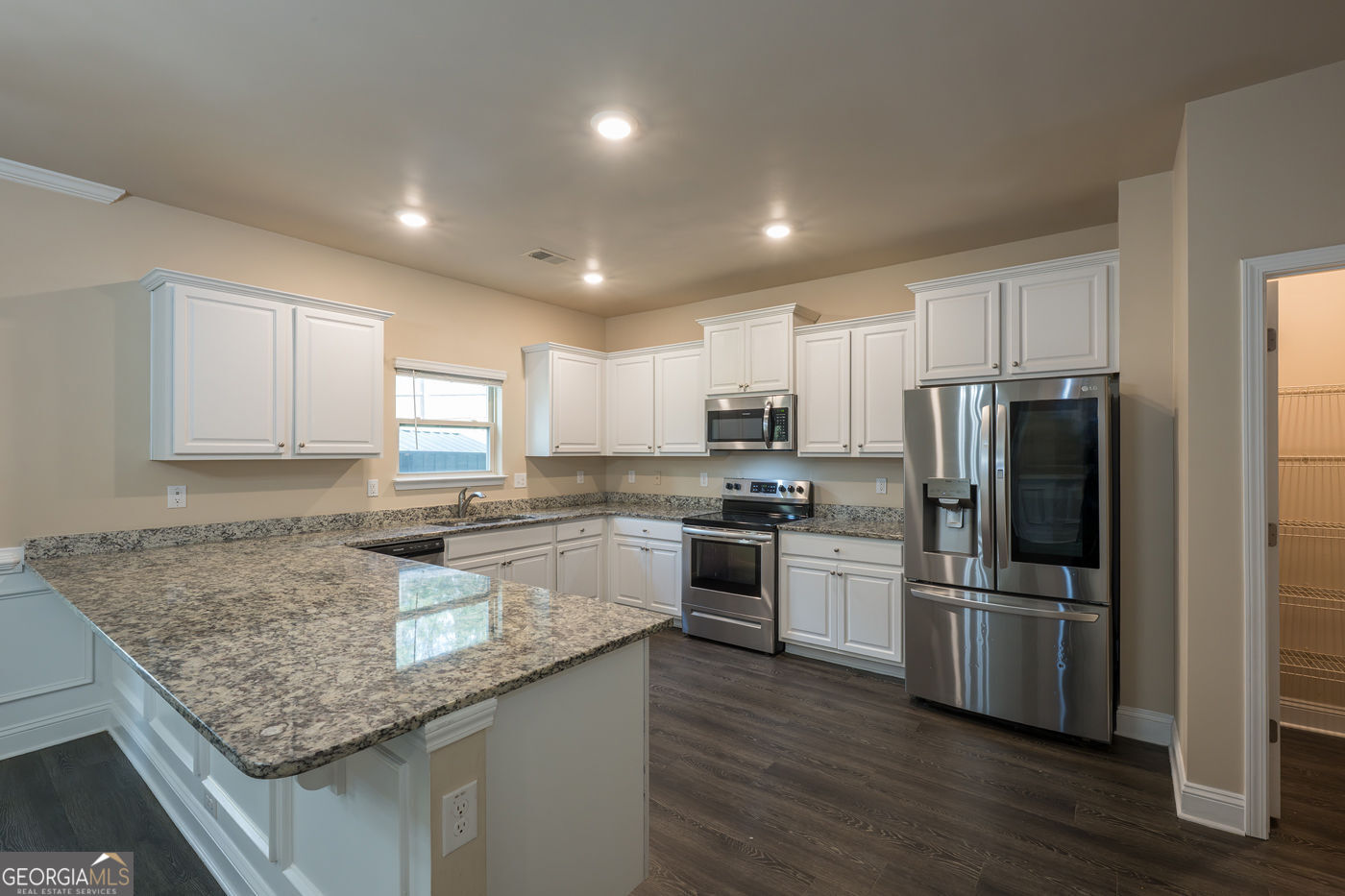 12172 Flannery Lane Hampton, GA 30228 - Photo 11 of 31 a kitchen with granite countertop stainless steel appliances and wooden cabinets