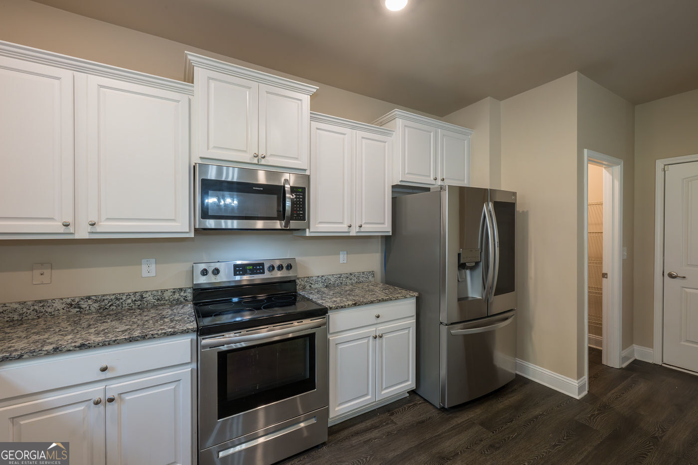 12172 Flannery Lane Hampton, GA 30228 - Photo 13 of 31 a kitchen with stainless steel appliances granite countertop a refrigerator stove and microwave