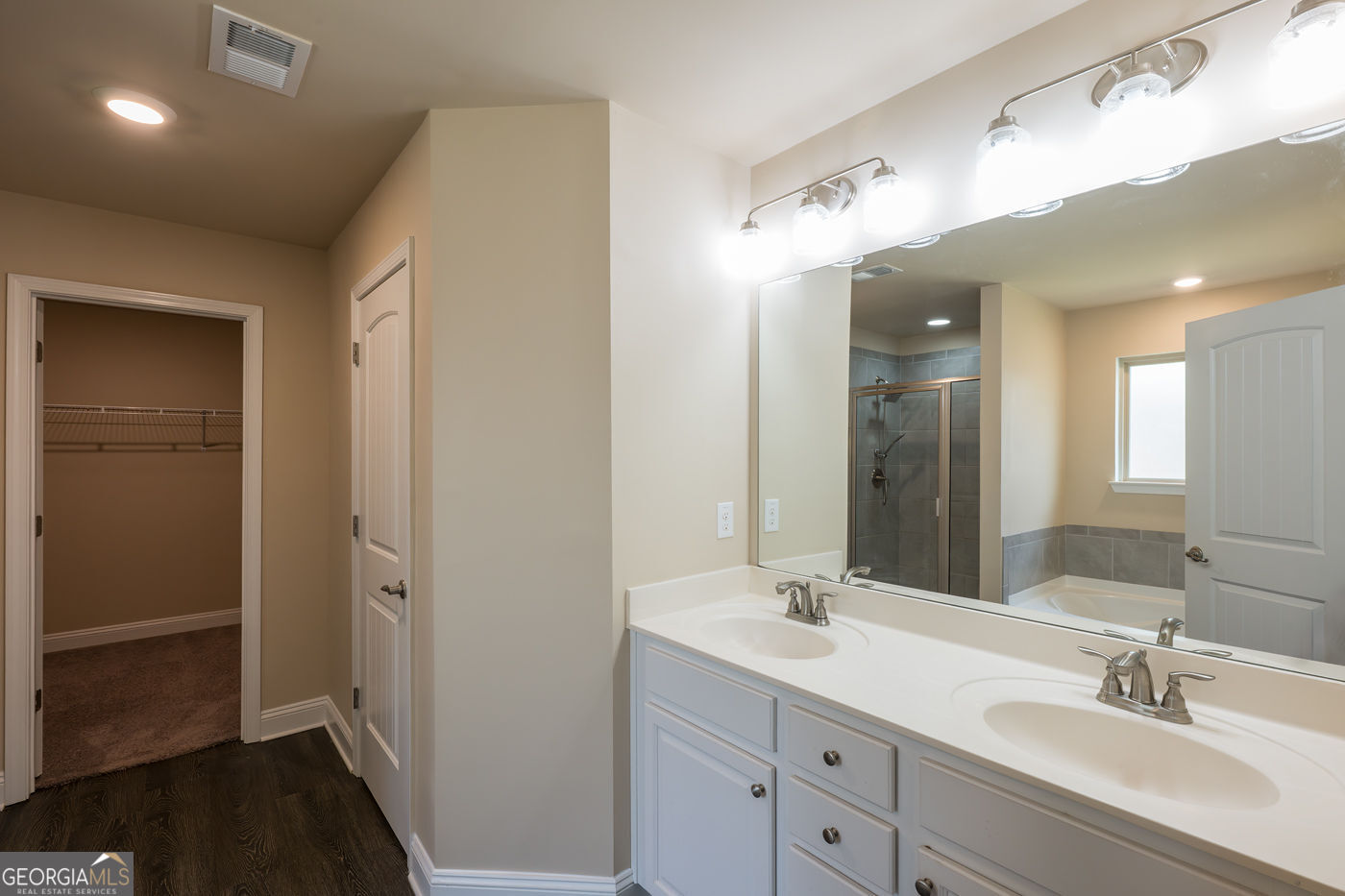 12172 Flannery Lane Hampton, GA 30228 - Photo 21 of 31 a bathroom with a double vanity sink and a mirror