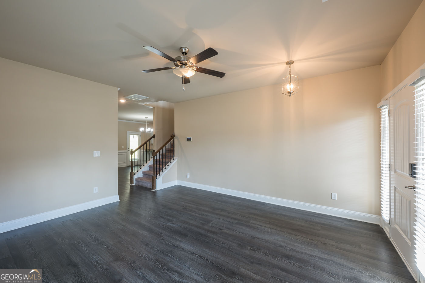 12172 Flannery Lane Hampton, GA 30228 - Photo 5 of 31 an empty room with wooden floor fan and windows