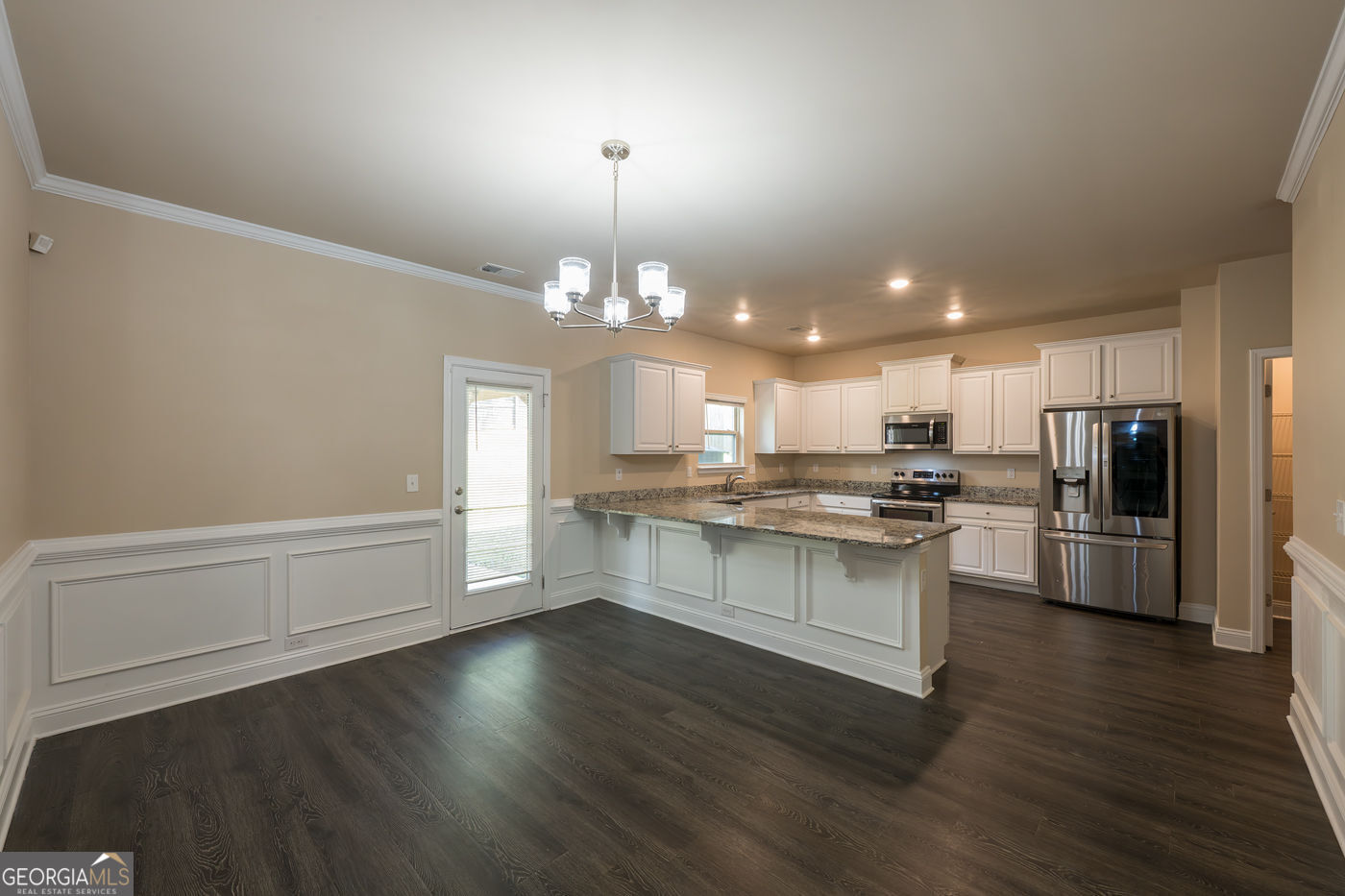 12172 Flannery Lane Hampton, GA 30228 - Photo 7 of 31 a kitchen with stainless steel appliances a refrigerator and a stove top oven