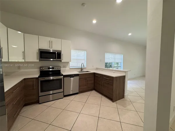 a kitchen with a sink and cabinets