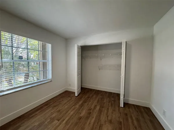 a white toilet sitting next to a shower