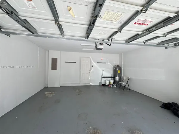 a view of a living room a refrigerator and a kitchen