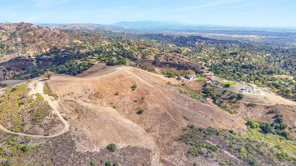 an aerial view of mountain with yard