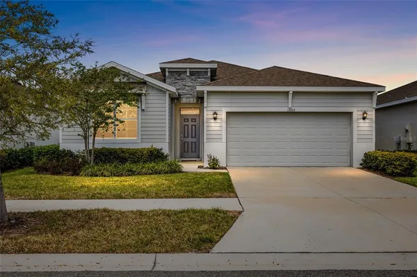 a front view of a house with a yard and garage