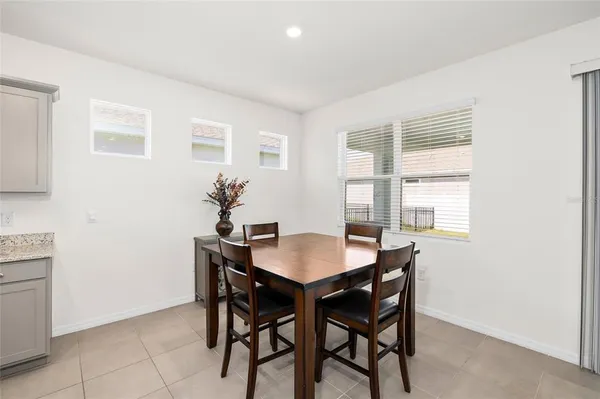 a dining room with furniture and window