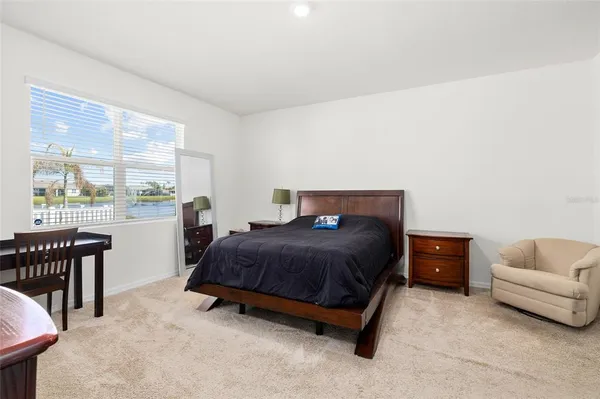 a bedroom with a bed and a couch