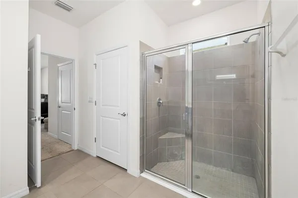 a bathroom that has a glass shower door