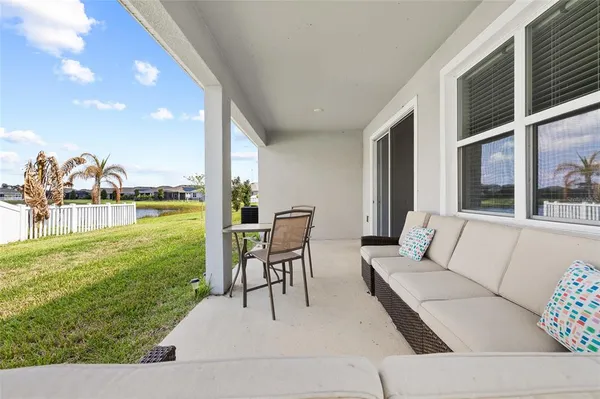a living room with patio furniture and garden view