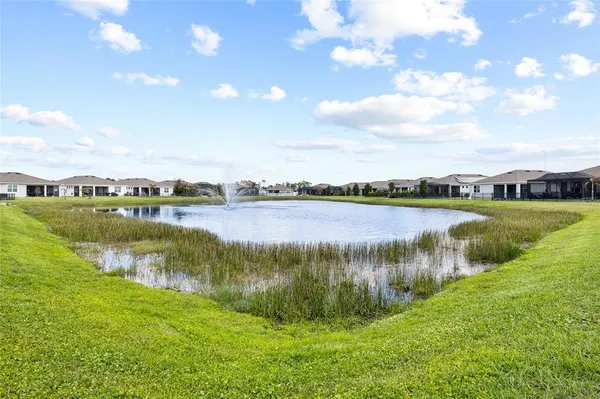 a view of a lake with houses in the back
