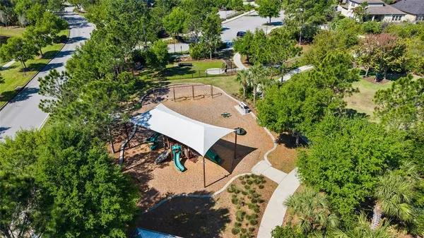 an aerial view of lake residential house with swimming pool and outdoor space