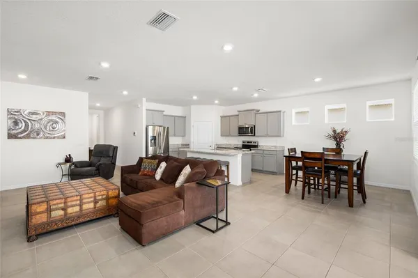 a living room with furniture and kitchen view