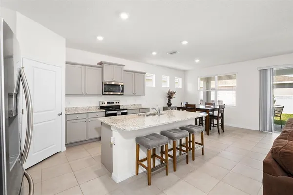 a kitchen with appliances a sink a counter top space and appliances